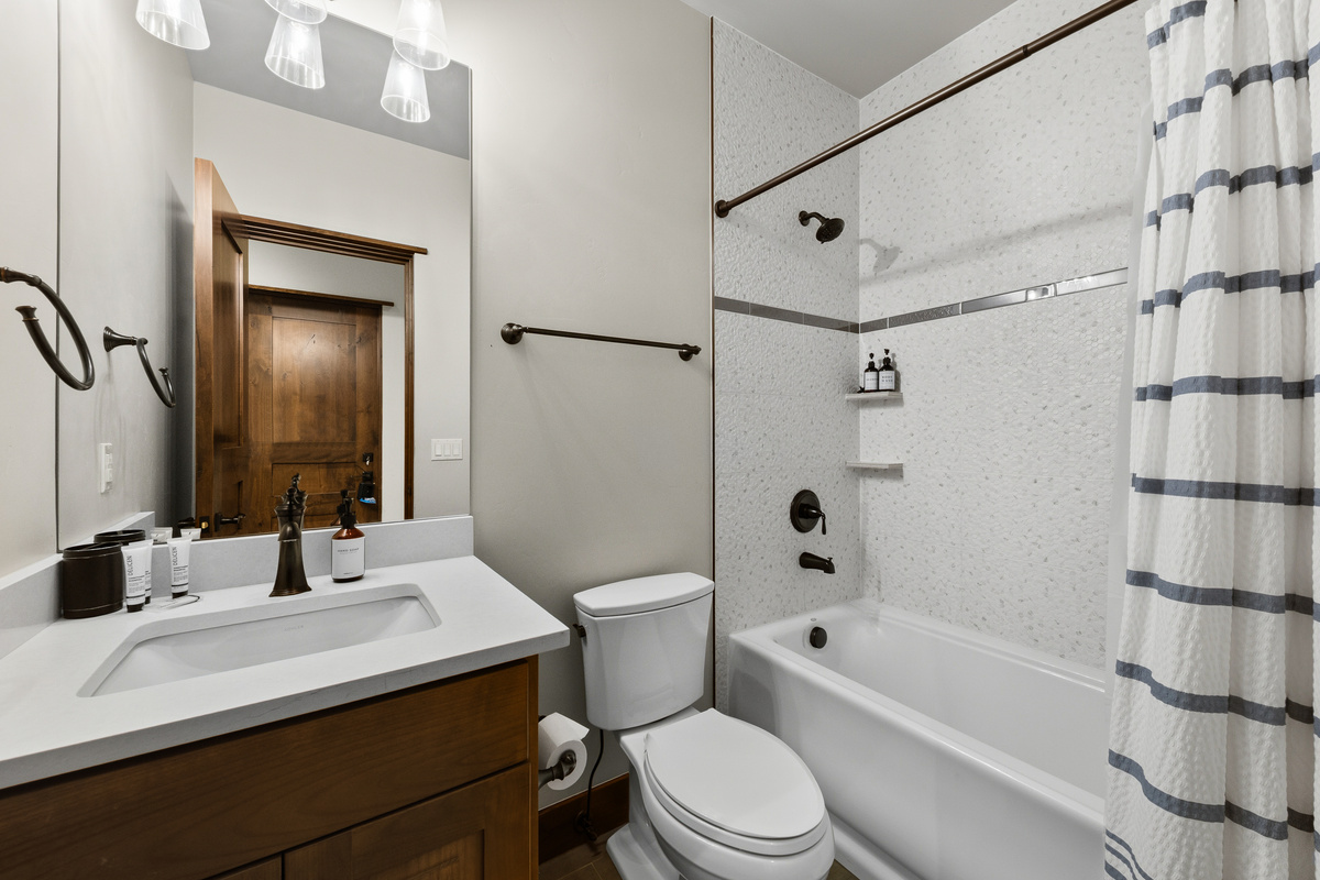 Full bathroom just off second living/family area with combo tub and shower on the lower level for the Queen bedroom and guests who use sofa sleeper.