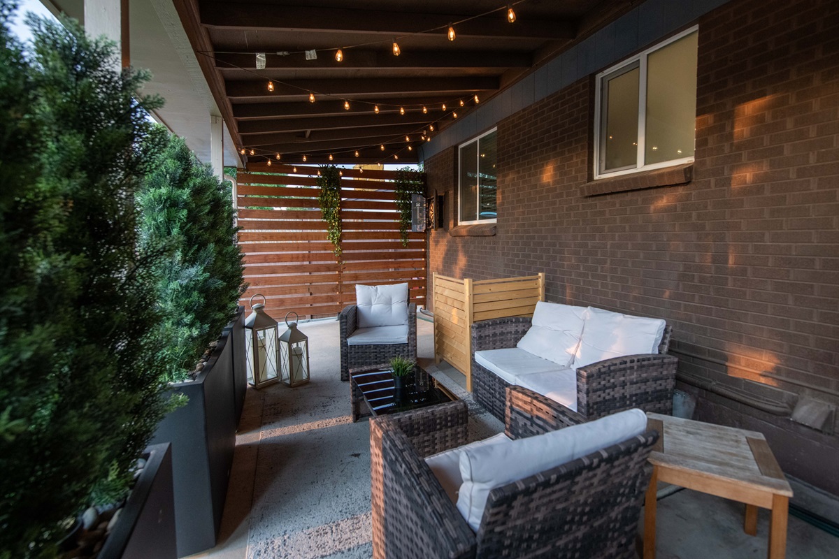 String-lit covered patio with premium lounge seating