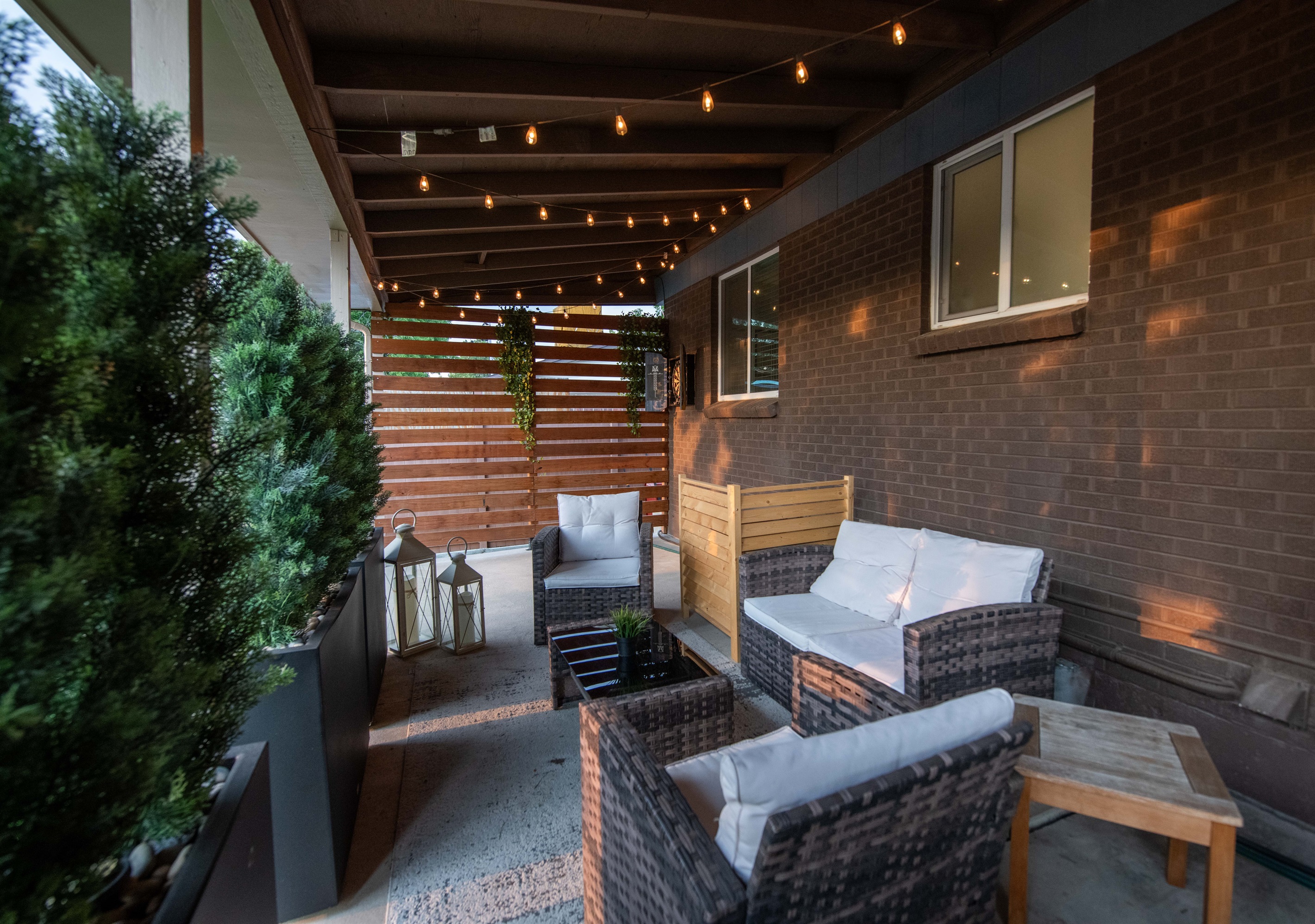 String-lit covered patio with premium lounge seating