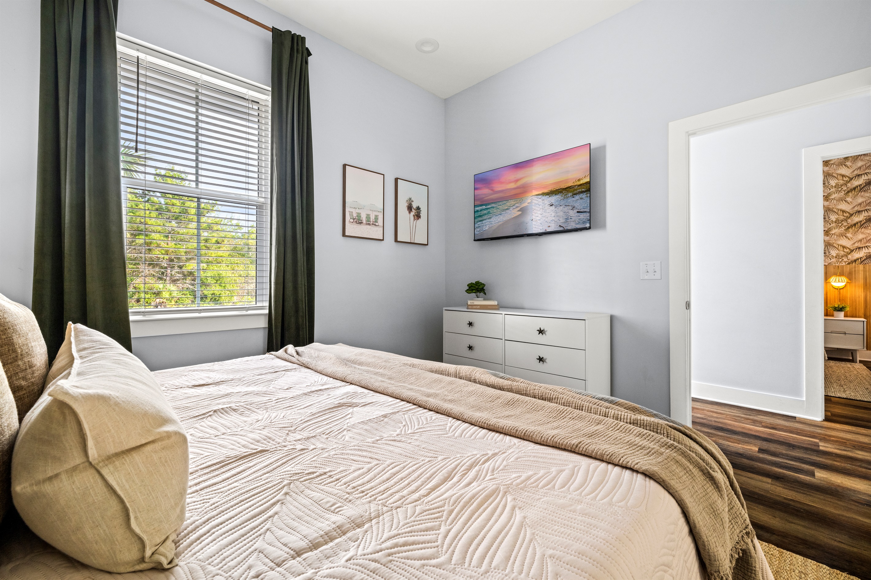 Soft bedding, natural light, and calm coastal design create the perfect place to rest after exploring Miramar Beach.