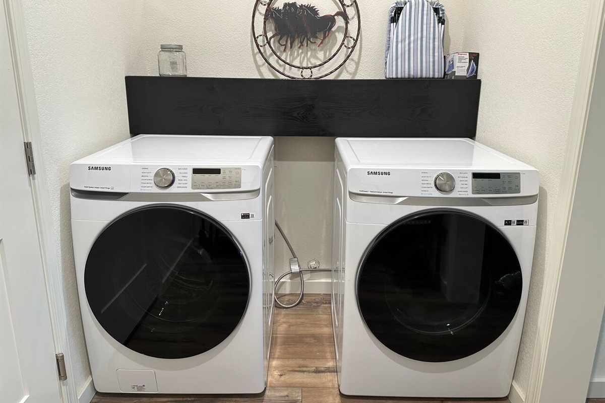 Laundry detergent and wool balls are there for your use along with an iron and board.    On the opposite side is a garment rack for jackets or hanging your laundry.   Shoe storage and bench to help you take off your shoes.  