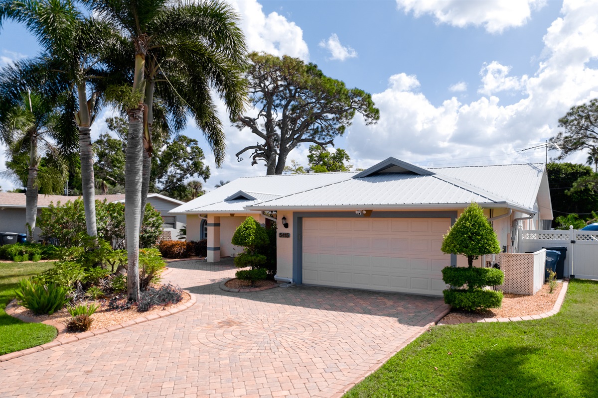 Pull right up to your relaxing retreat. The well-lit driveway and stunning facade make every arrival feel like coming home.