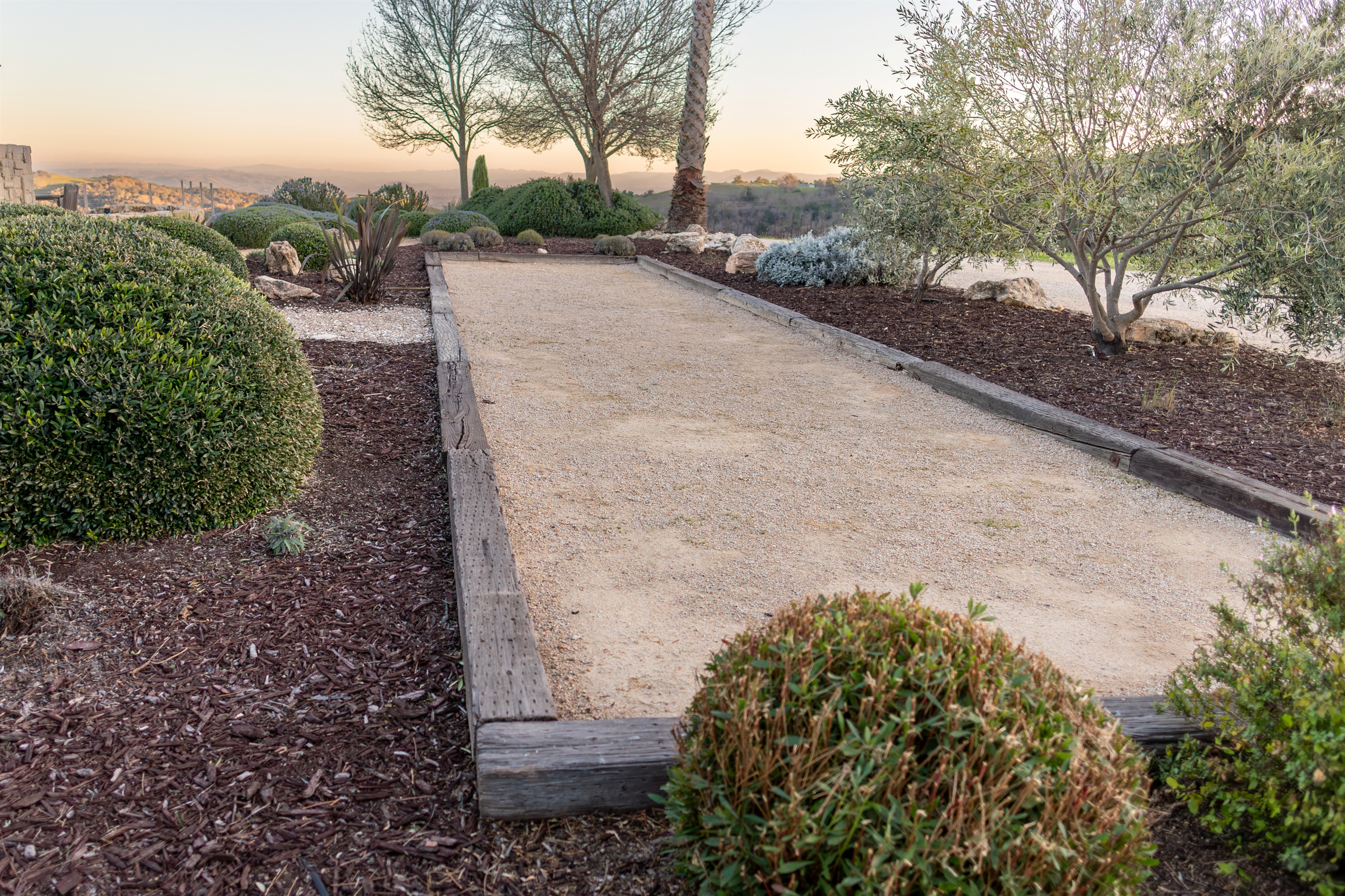 Grab a glass of wine and challenge your travel companions to a match. The hilltop bocce court is tucked into the native landscaping with the Paso Robles hills glowing at golden hour behind you.