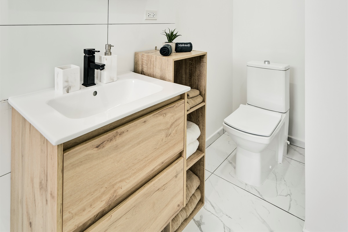 Modern Vanity with Sleek Sink & Warm Wood Cabinetry