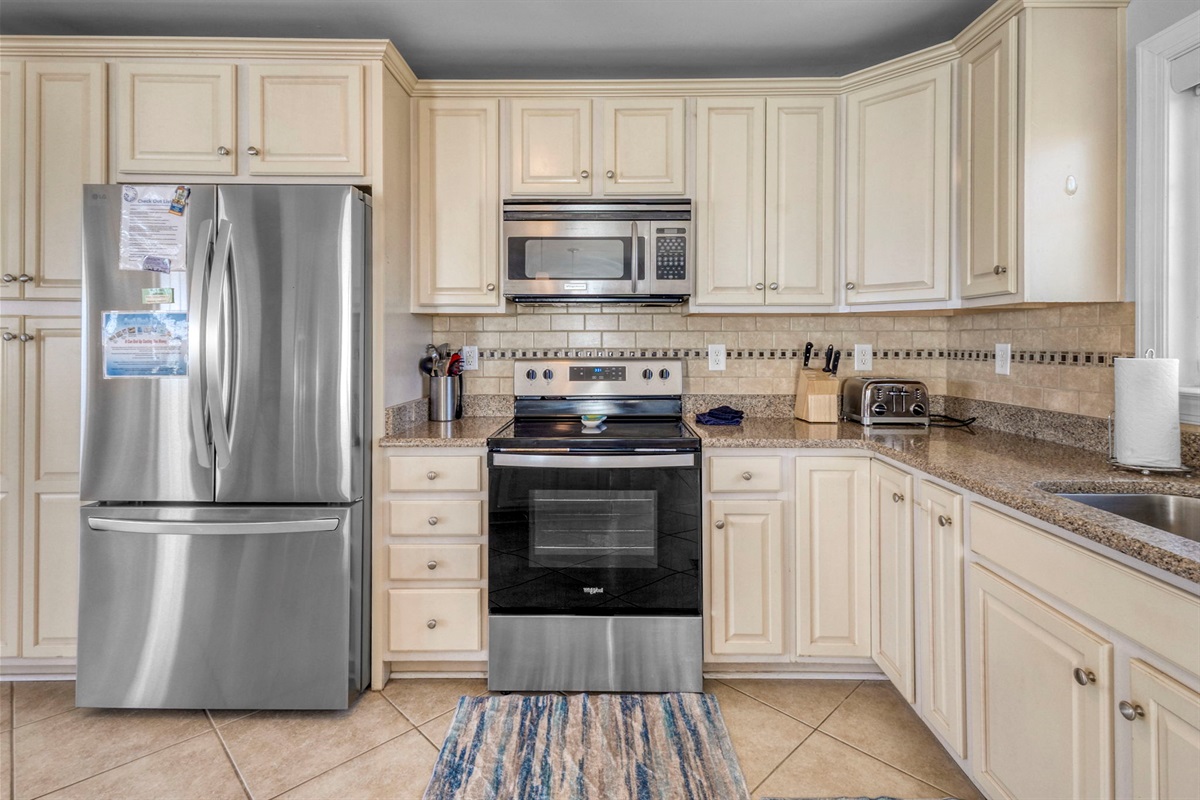 The french door refrigerator has plenty of space and a pull out freezer drawer with an icemaker. The stove is glass top with a roomy oven.