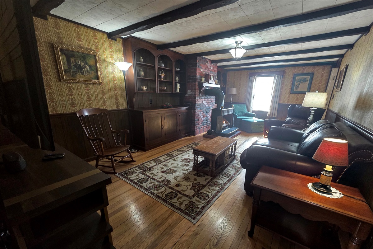 Relax in the rustic, cozy living room featuring a propane fireplace and Smart TV—perfect for unwinding after a day of exploring.