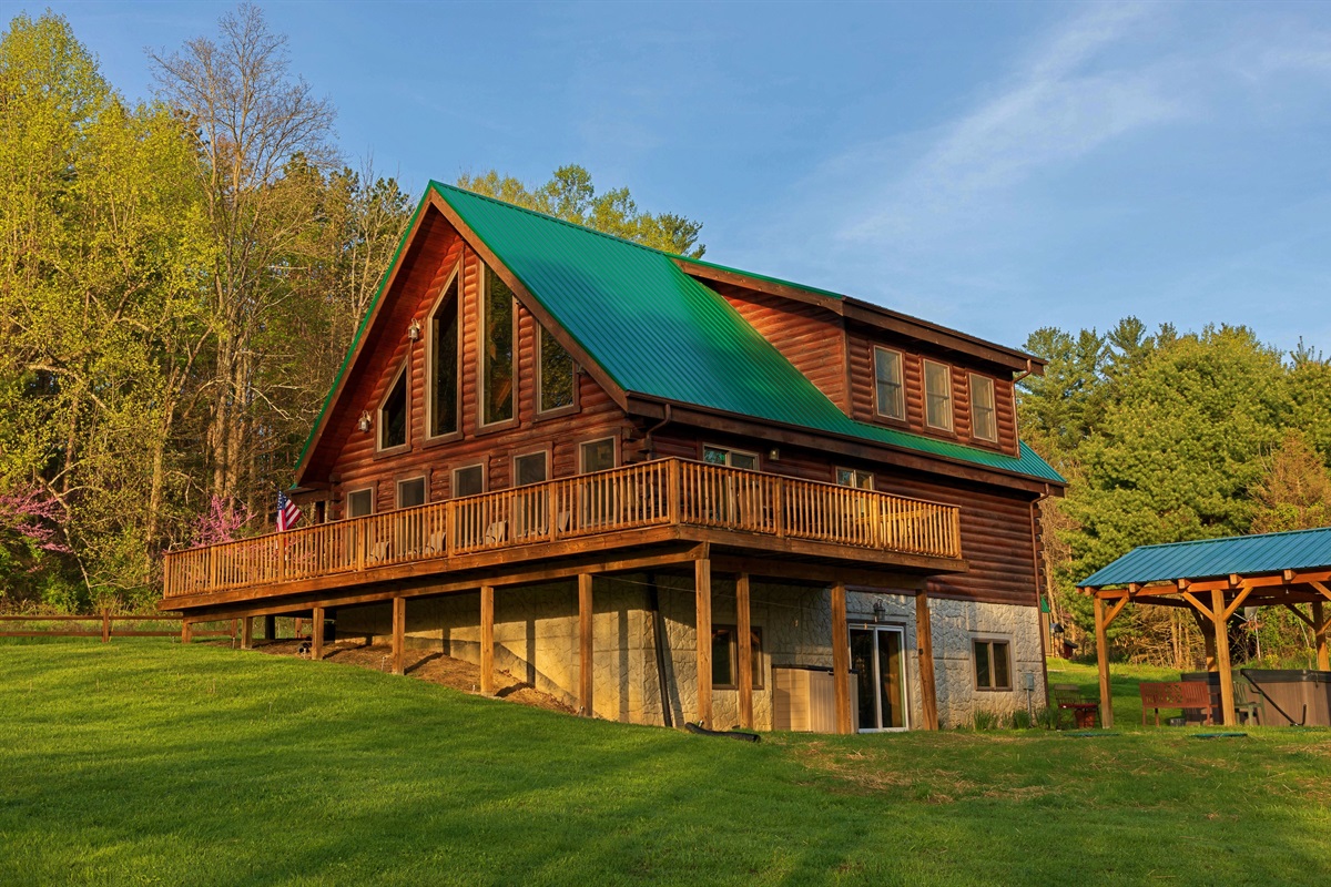 The Lodge in the springtime. Notice the wrap around porch and the walk out lower level to covered hot tub. 