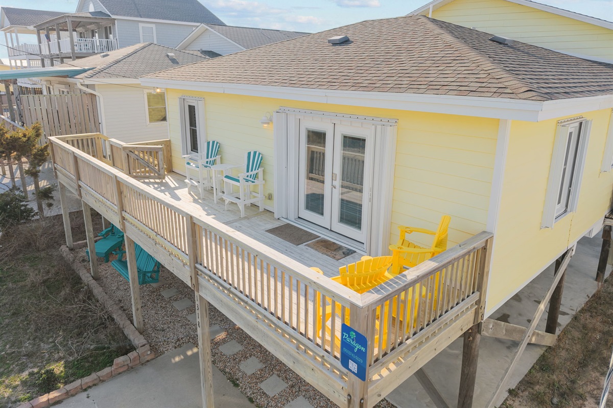 Aerial view of the home showcasing the expansive wraparound balcony and surroundings