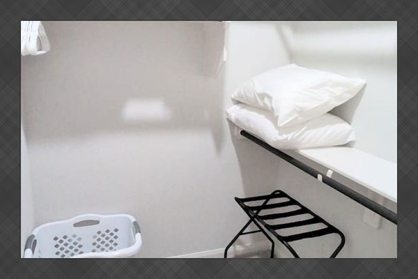 Large primary closet with extra pillows & towels, luggage racks, hangers and a laundry hamper.  Bedding for the full sized sofa bed also included. 