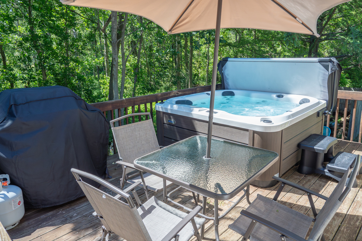 Deck with hot tub, gas grill, and patio table