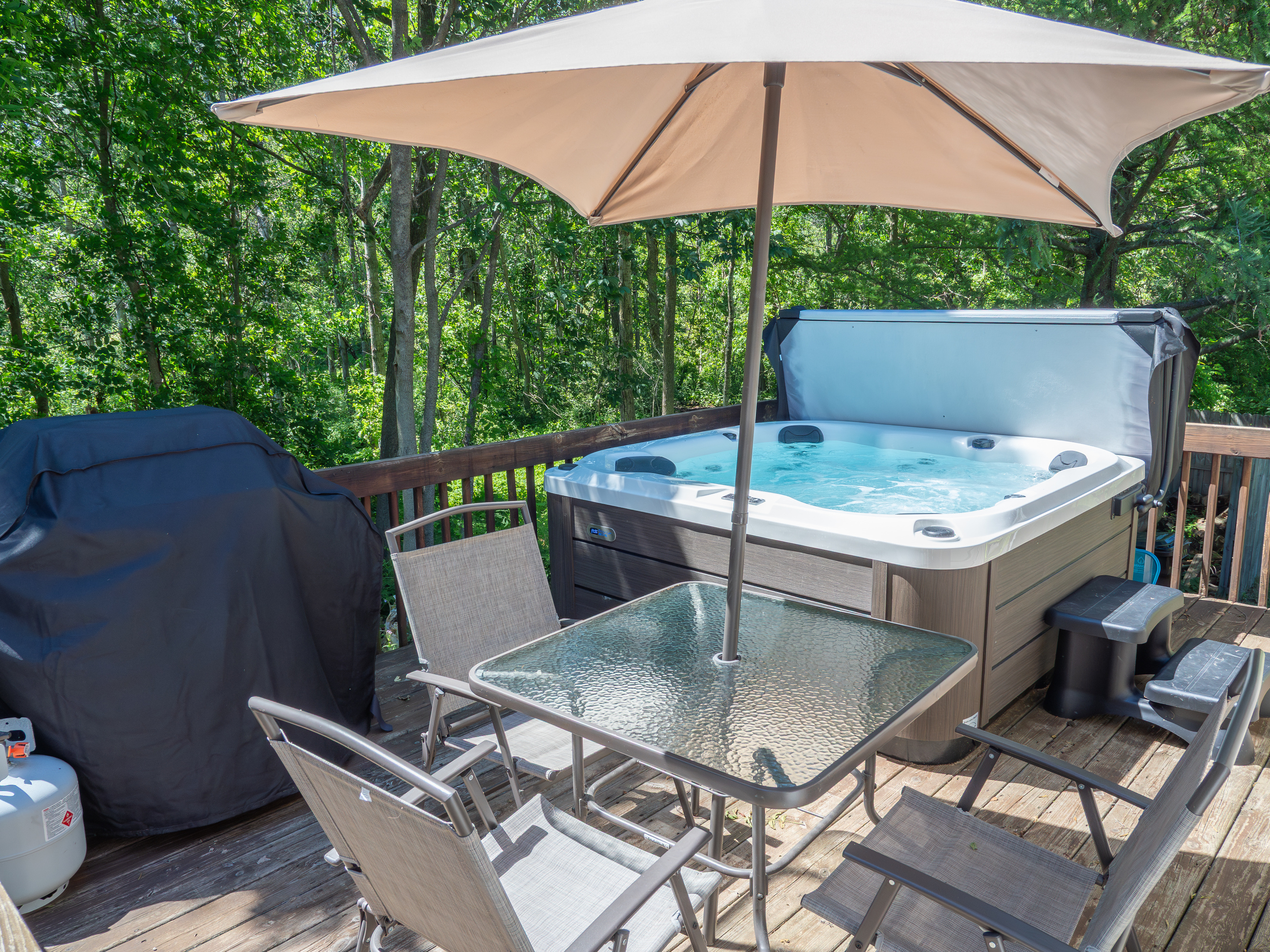 Deck with hot tub, gas grill, and patio table