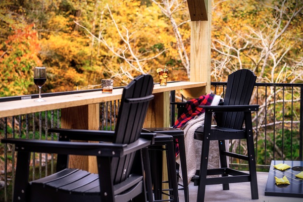 This a bar table area that overlooks the Little Pigeon River. Enjoy a conversation with your loved ones!