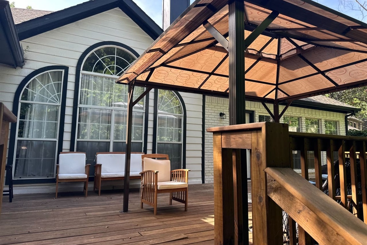 Covered patio with grill for outdoor dining and entertaining.