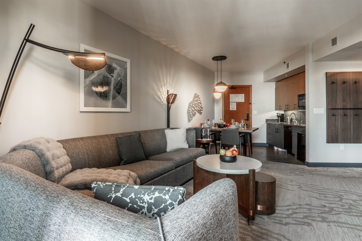 The sectional anchors an open, connected space that blends living, dining, and kitchen areas.