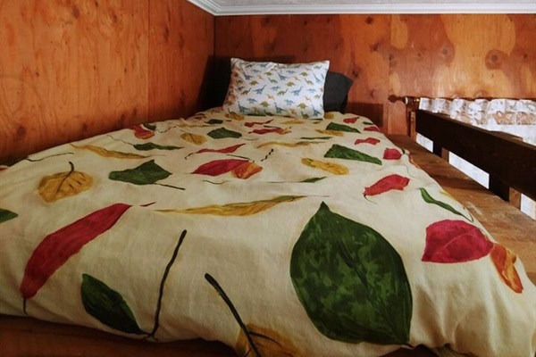 Loft- Twin mattress in primary bedroom above bed.