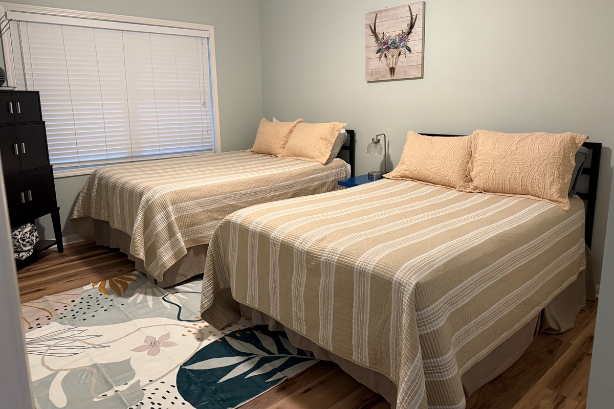 Walkout level bedroom features queen and full bed.