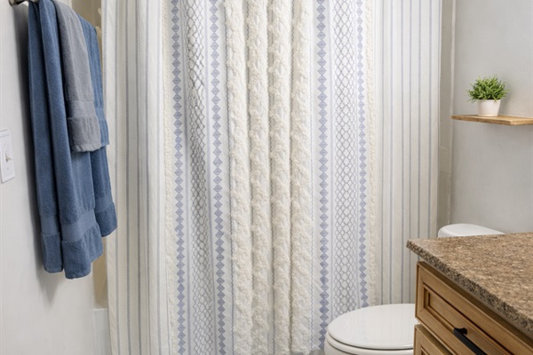 Bright, clean bathroom with full tub/shower