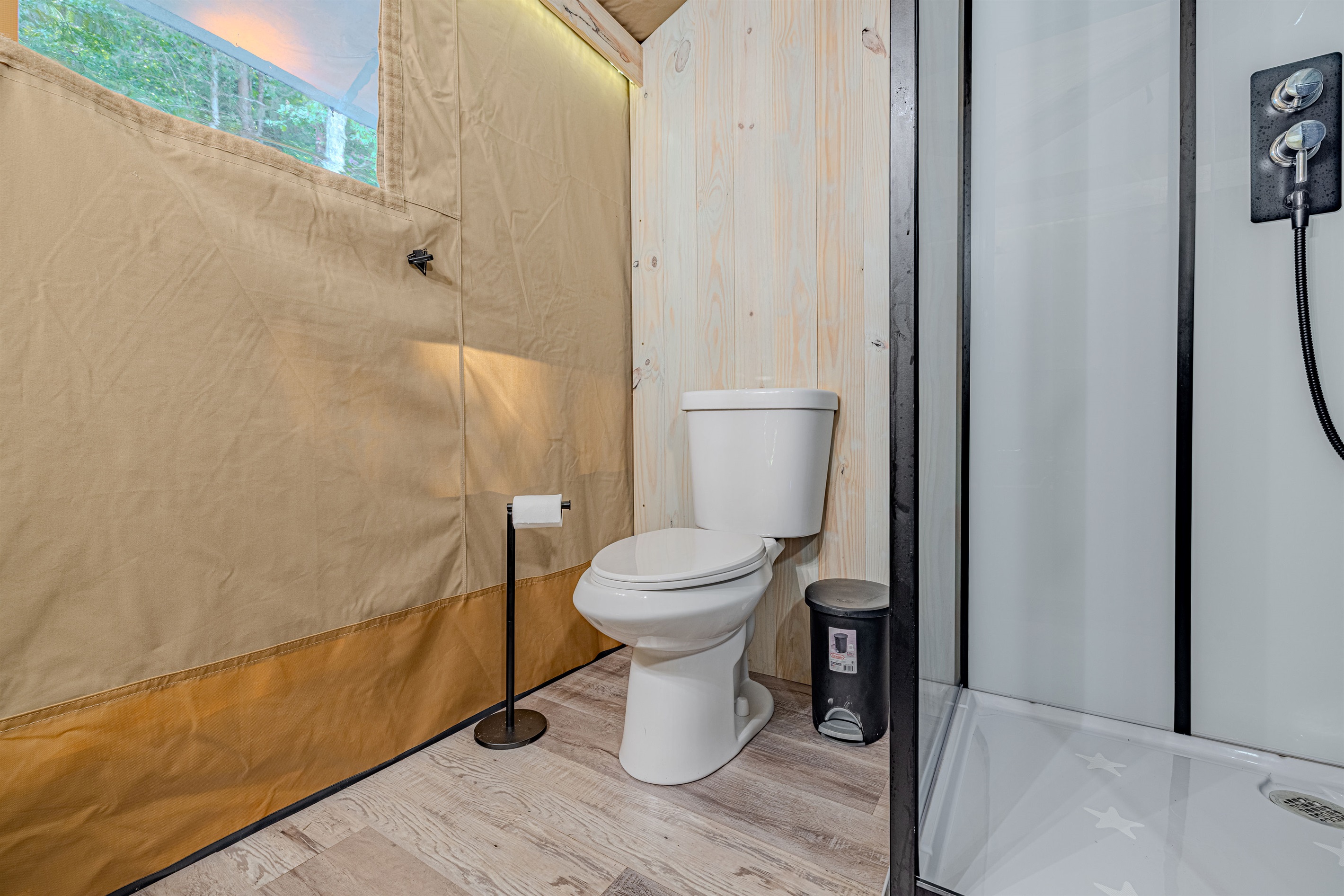 Privacy and convenience are non-negotiable. We've ensured your stay includes a modern, conventional toilet, surrounded by natural pine wood paneling for a clean, private experience.
