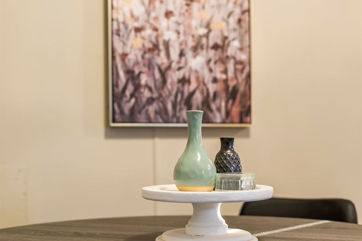 Artful centerpiece with decorative vases, adding a stylish touch to the dining setup.