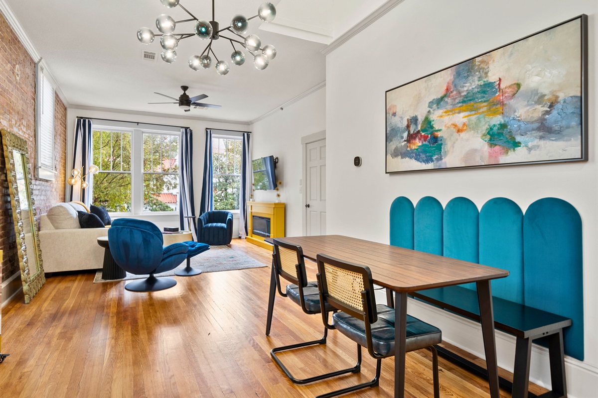 The dining area seamlessly flows into the living space, creating an open and inviting layout for enjoying meals or company.