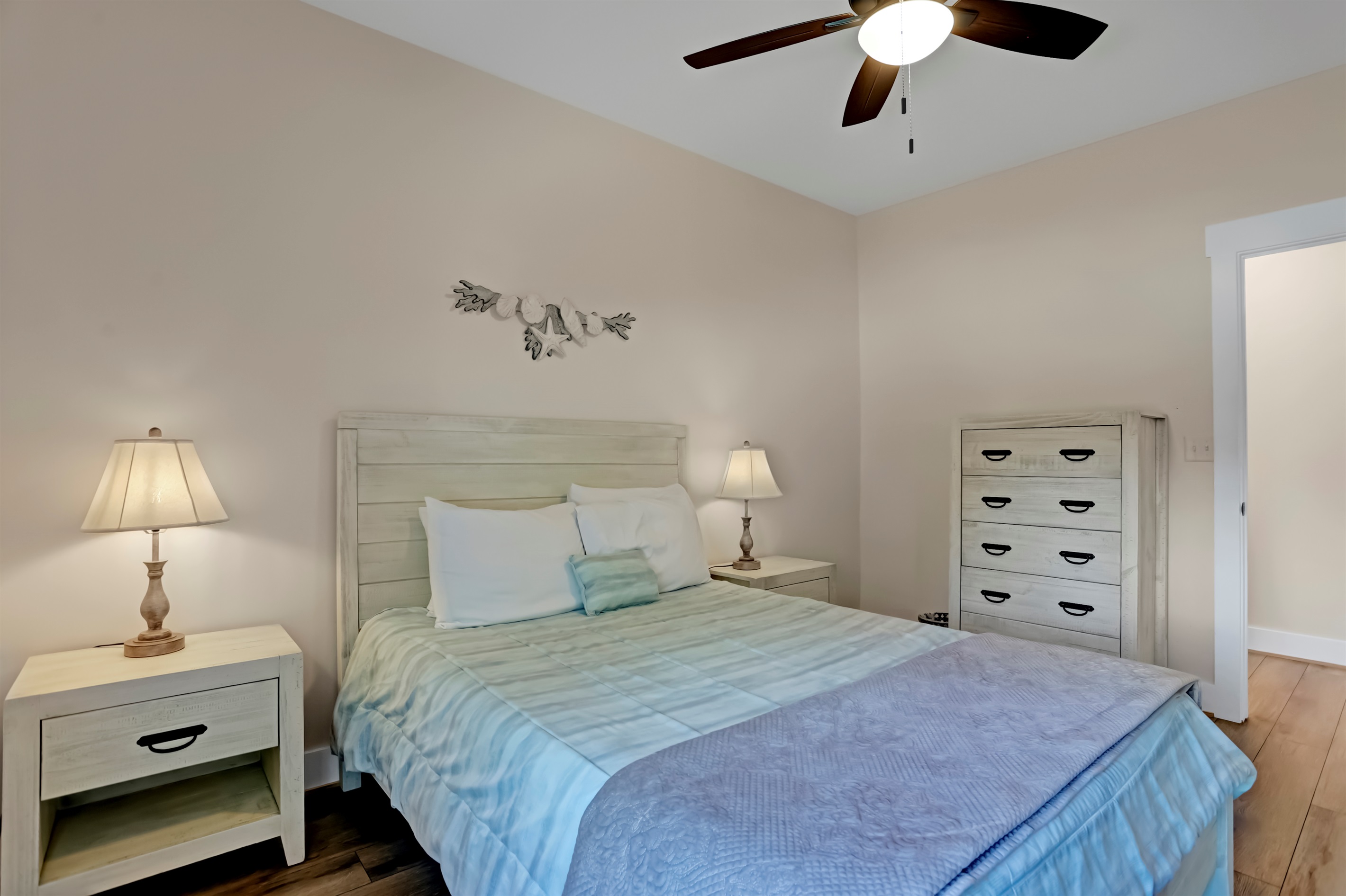 Cozy bedding and soft lighting create a peaceful guest retreat.