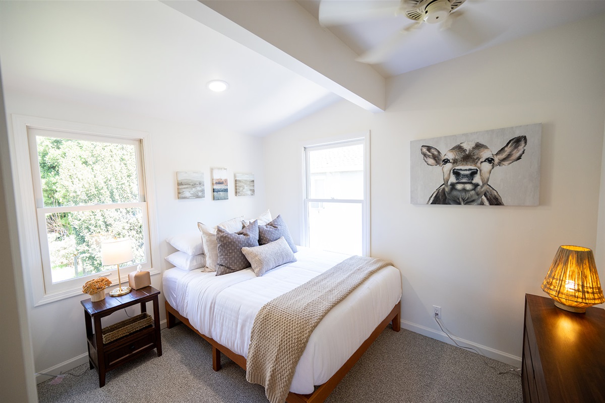 Second bedroom featuring a queen bed with comfortable linens and a quiet, relaxing atmosphere