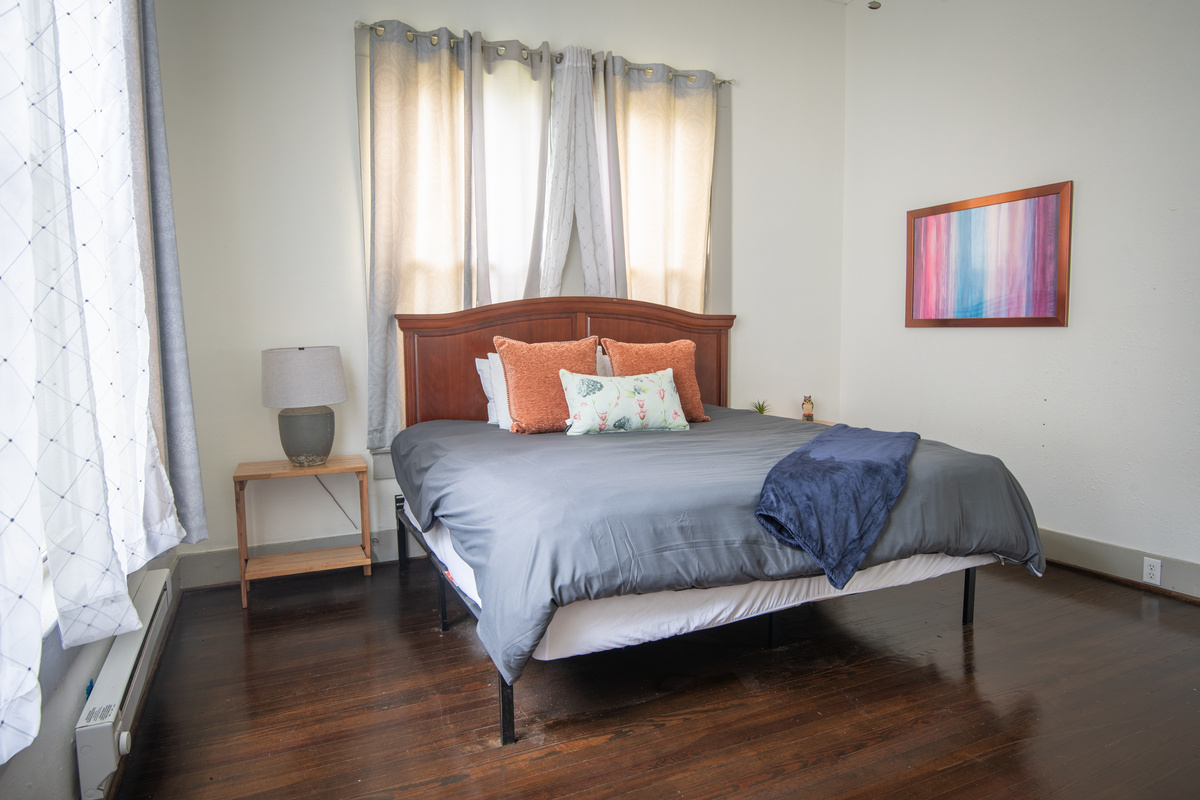 Large windows fill the room with natural light, creating a bright and peaceful space to start your day or settle in for a restful evening.
