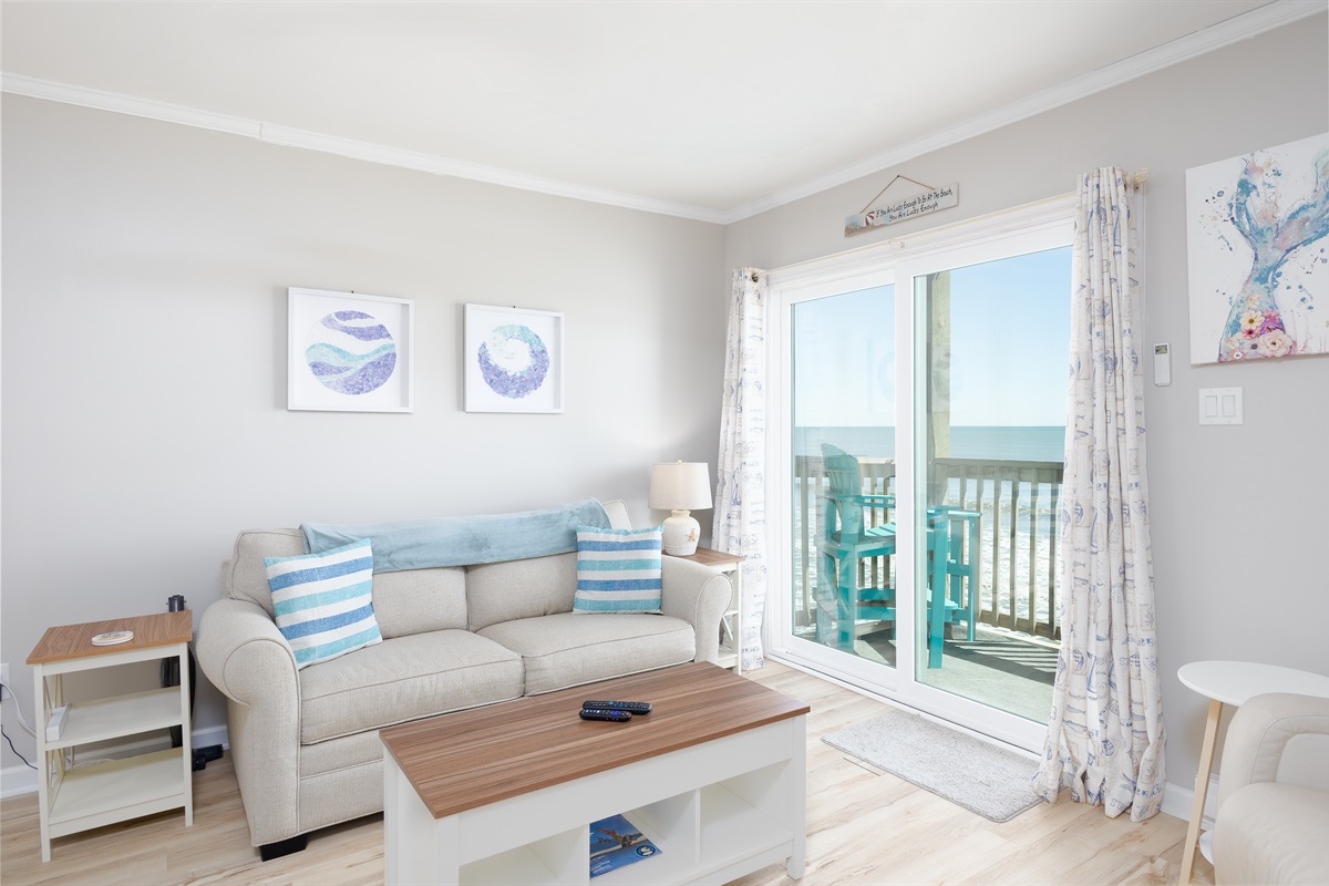 Modern coastal living room with balcony access