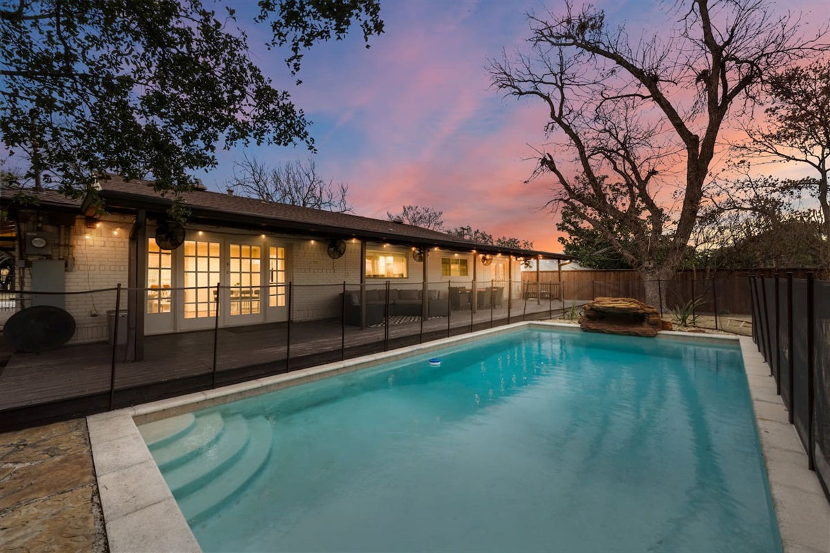 Catch a true Texas sunset in this spacious backyard, adorned with a large pool and ample outdoor seating and amenities! 