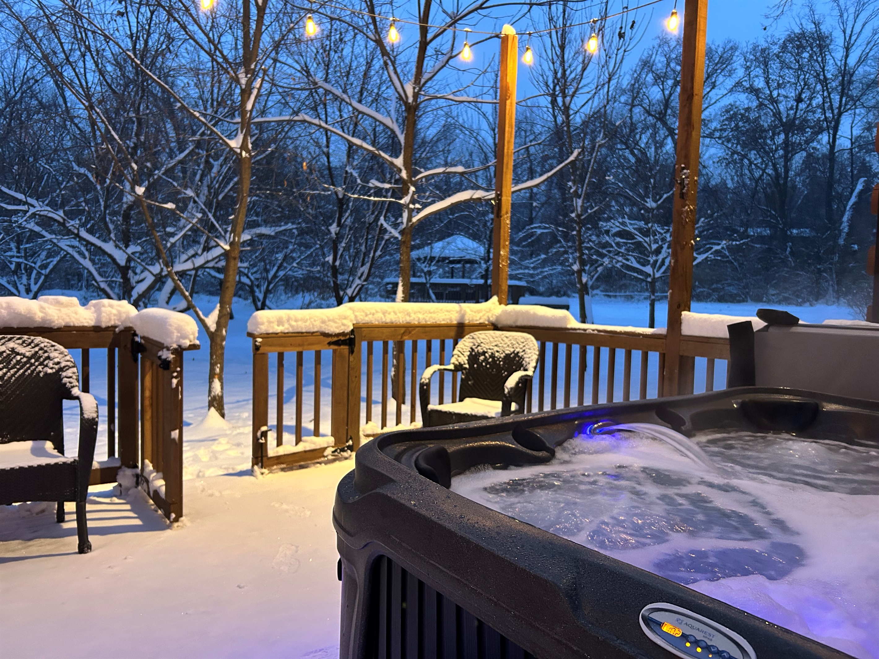 Relax in the hot tub under the cafe lights on a cold winter night.