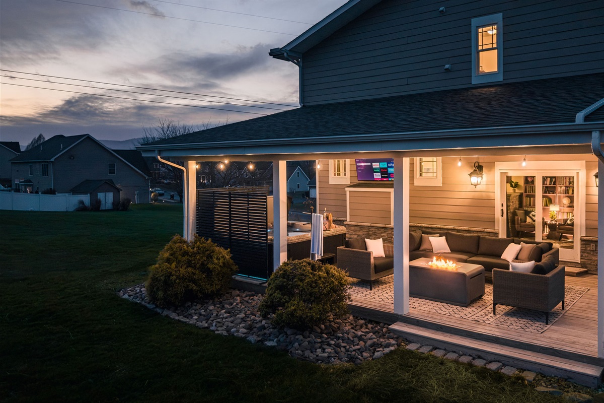 Covered outdoor lounge perfect for evening conversations, morning coffee, or relaxing year-round.