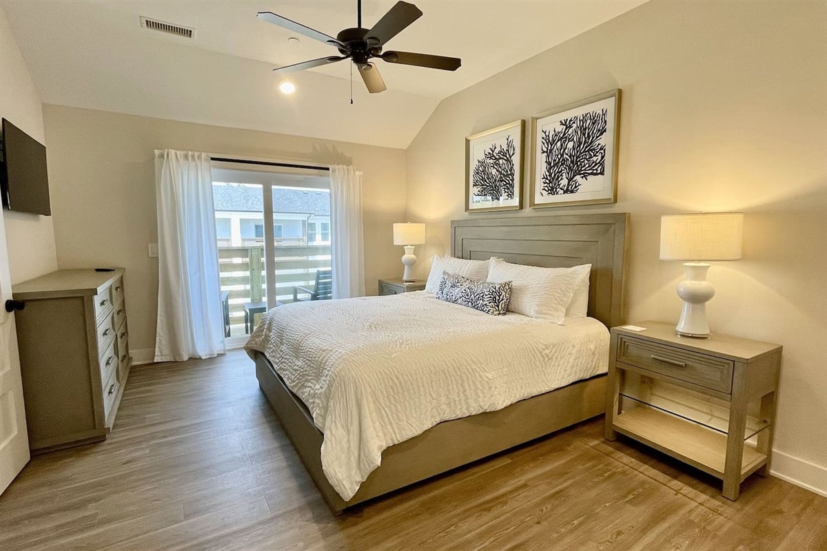 Inviting King bedroom with soft linens, warm lighting, and a restful atmosphere