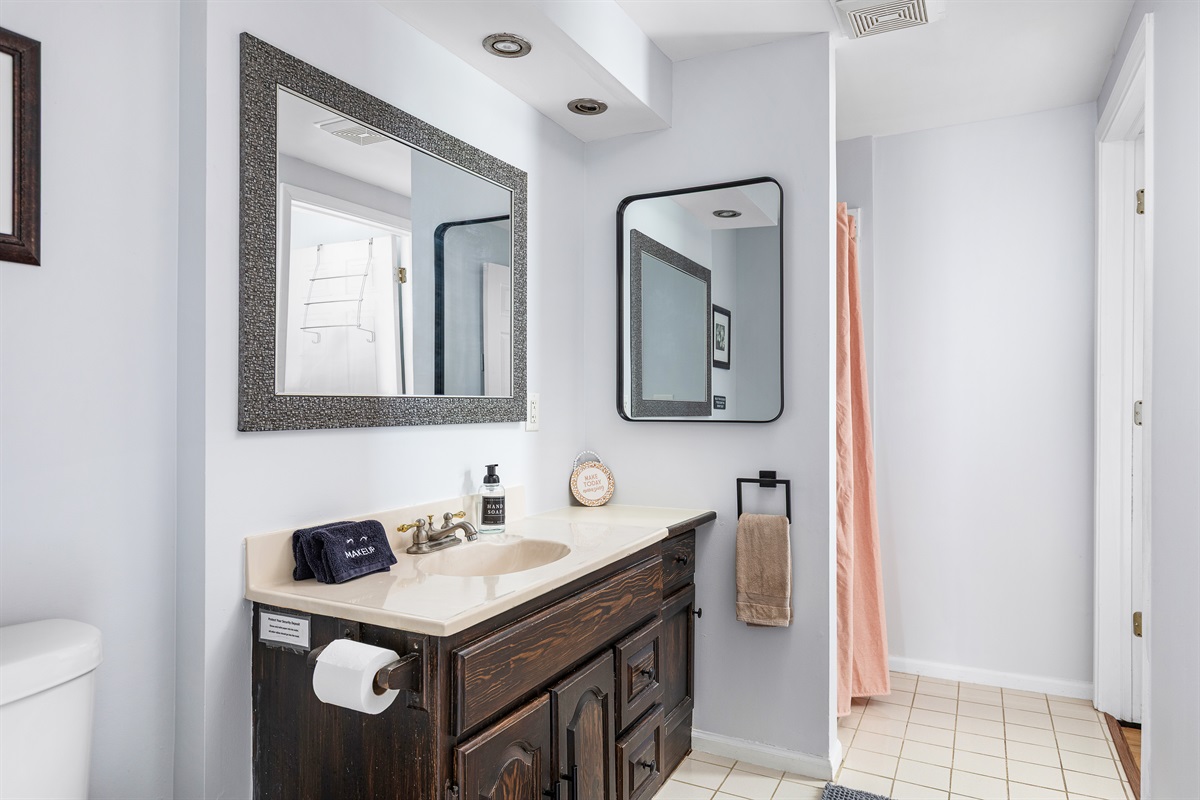 This convenient first floor bathroom with standing shower makes coming and going effortless after beach days.
