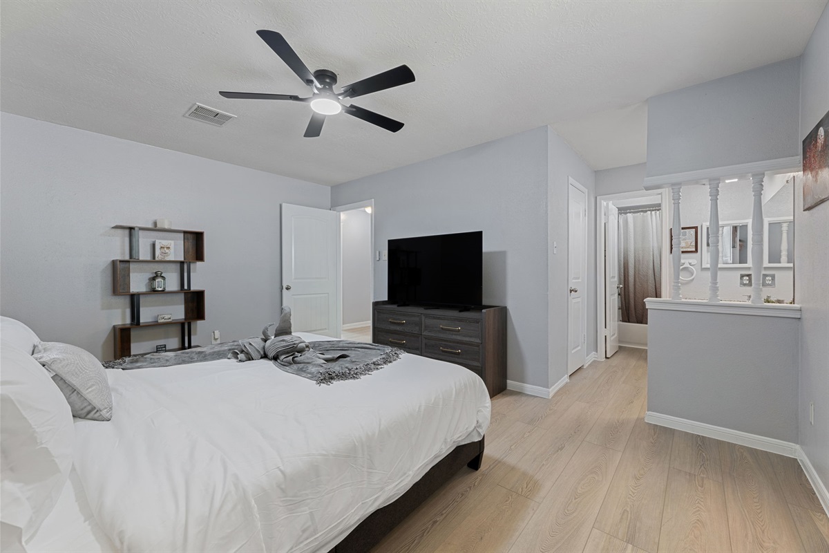 Retreat to the luxurious master suite with a king bed, private bath, and TV for ultimate comfort and privacy.