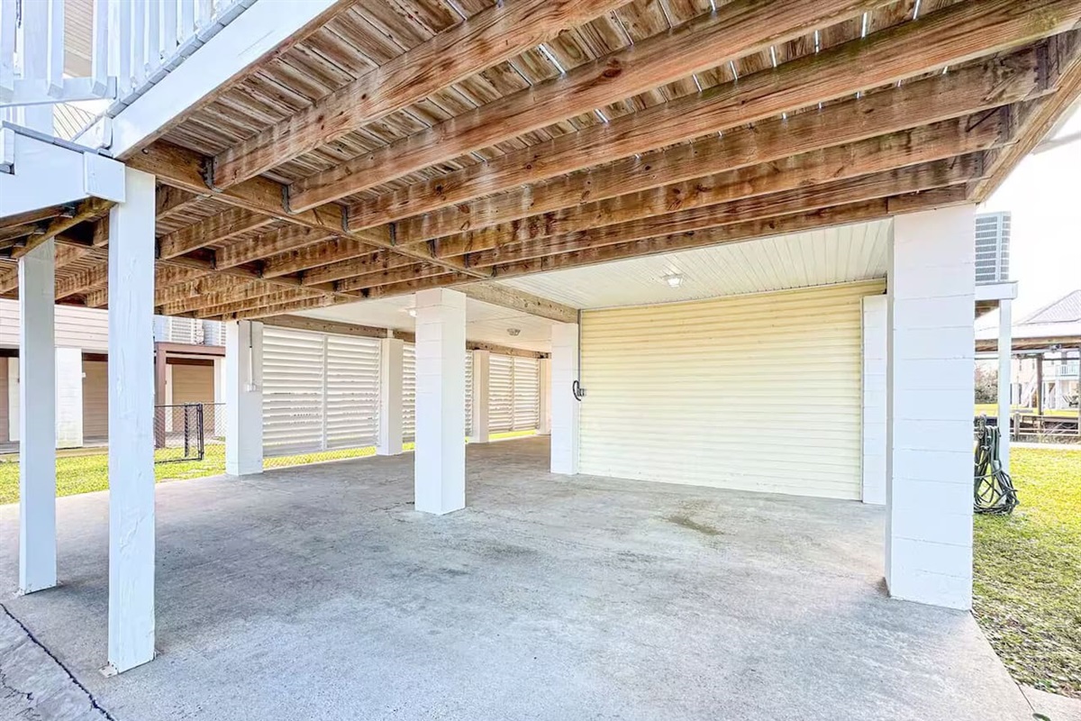 Open covered space with comfortable seating and ample room for lounging, parking, or storing beach gear.