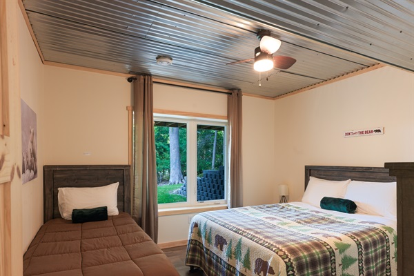 Lower level bedroom 3 with 1 queen + 1 twin XL, overlooking the lake