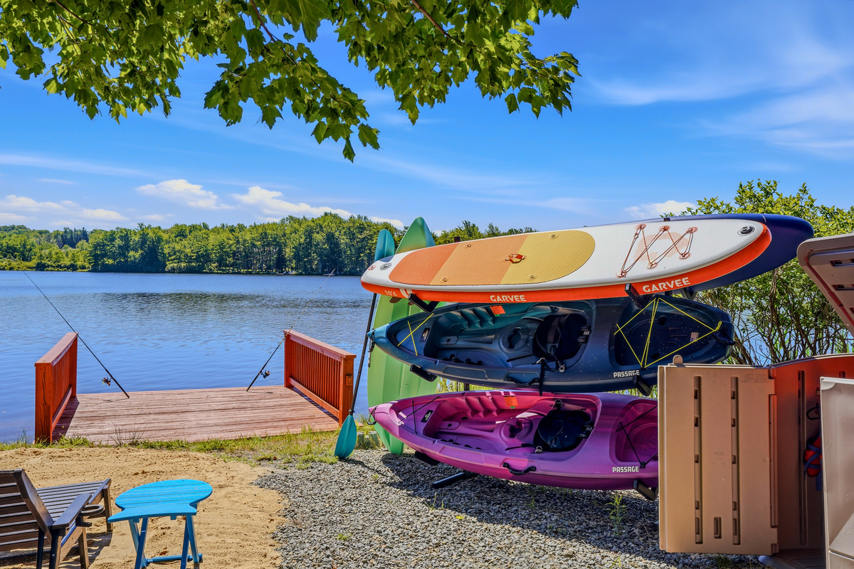 Private dock stocked with kayaks and stand-up paddleboards — the water is steps from your door