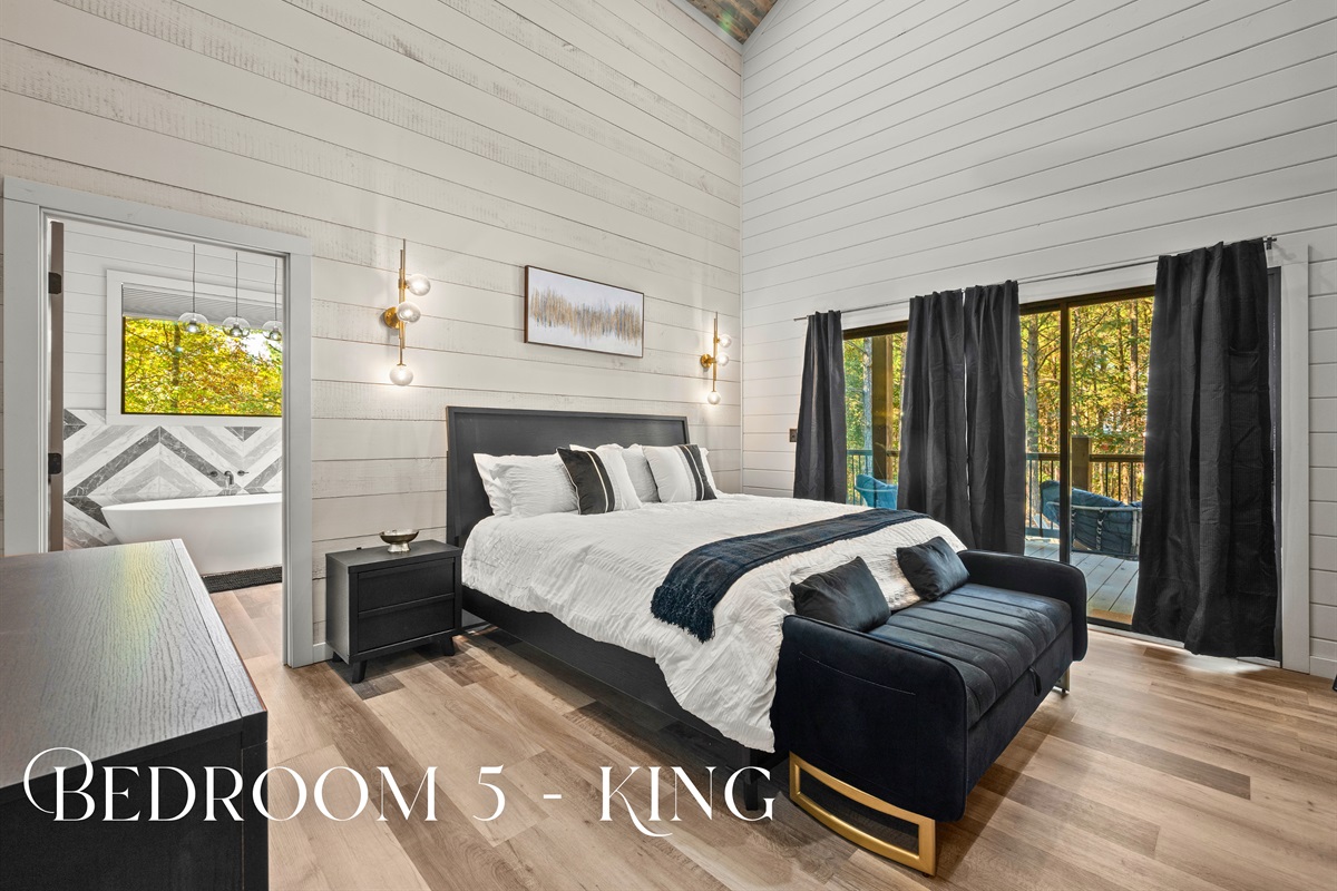 Sleek design meets timeless comfort in this king suite, complete with a stylish accent wall and tranquil wooded views.