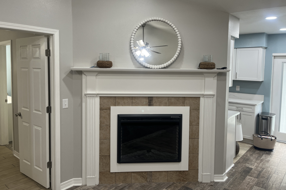 Working electric fireplace. Remote control. Warms up the room with a cozy atmosphere.