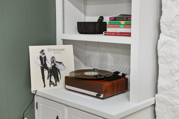 Spin a record on the vintage turntable or connect your phone via Bluetooth to fill the room with your favorite music.