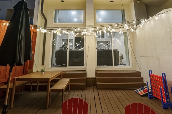 Enjoy outdoor dining, string lights for evening ambiance, and classic yard games including Connect 4 and cornhole.