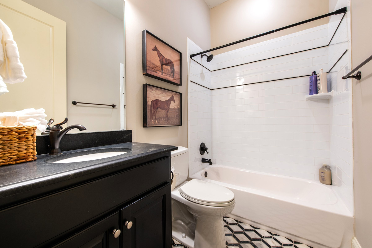 Full bath with tub/shower combo, serving Bedroom 3.