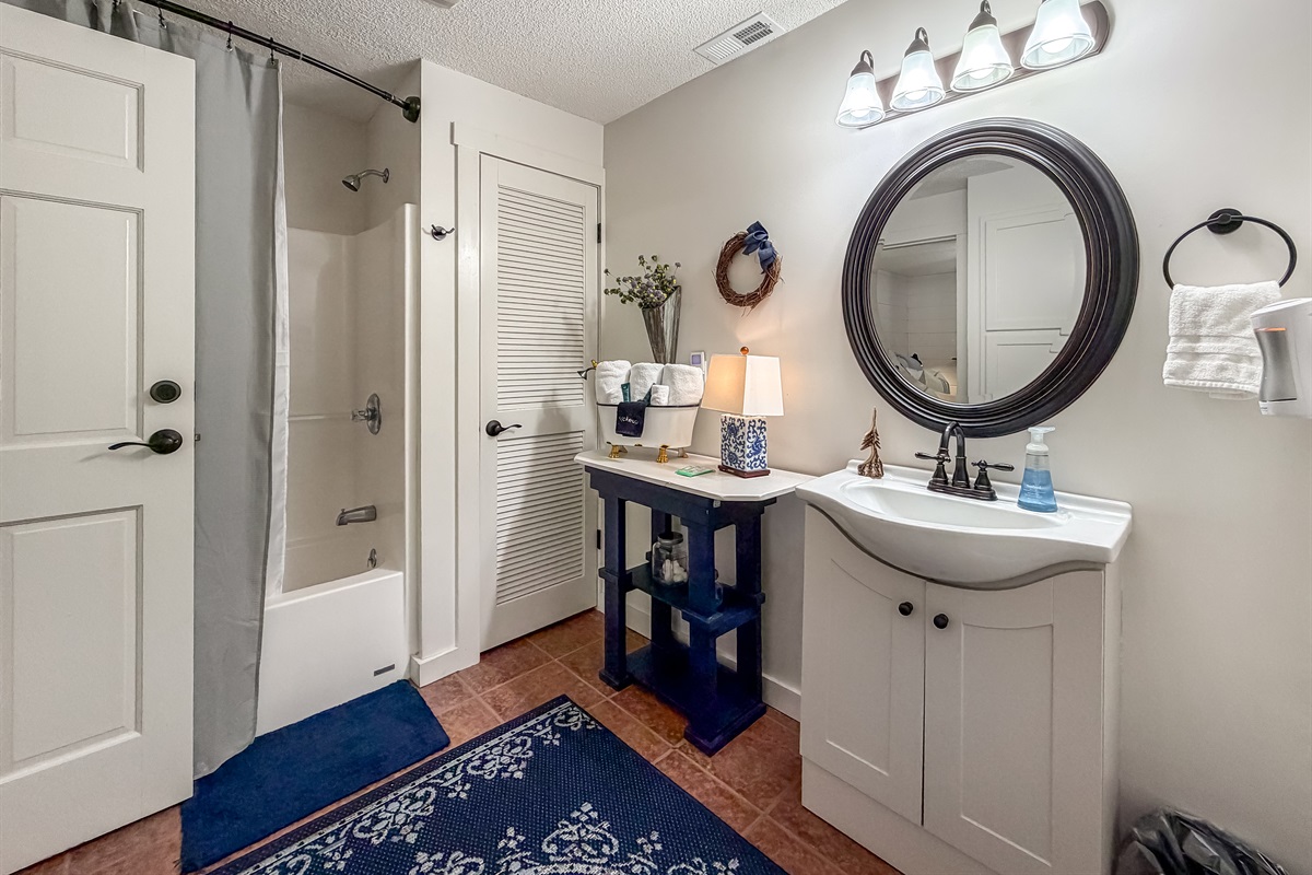 Vanity area and tub/shower combo.
