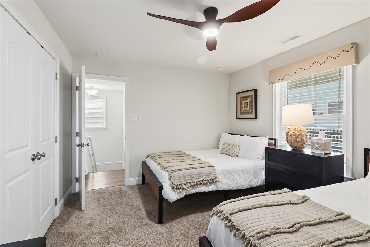 Peaceful twin bedroom with coastal accents and soft carpeting

