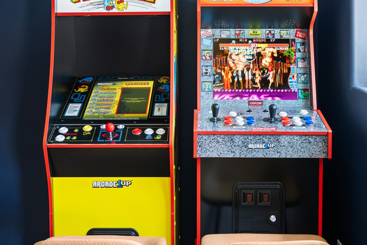 Retro gaming corner with classic arcade machines: Pac-Man and Street Fighter II Turbo.