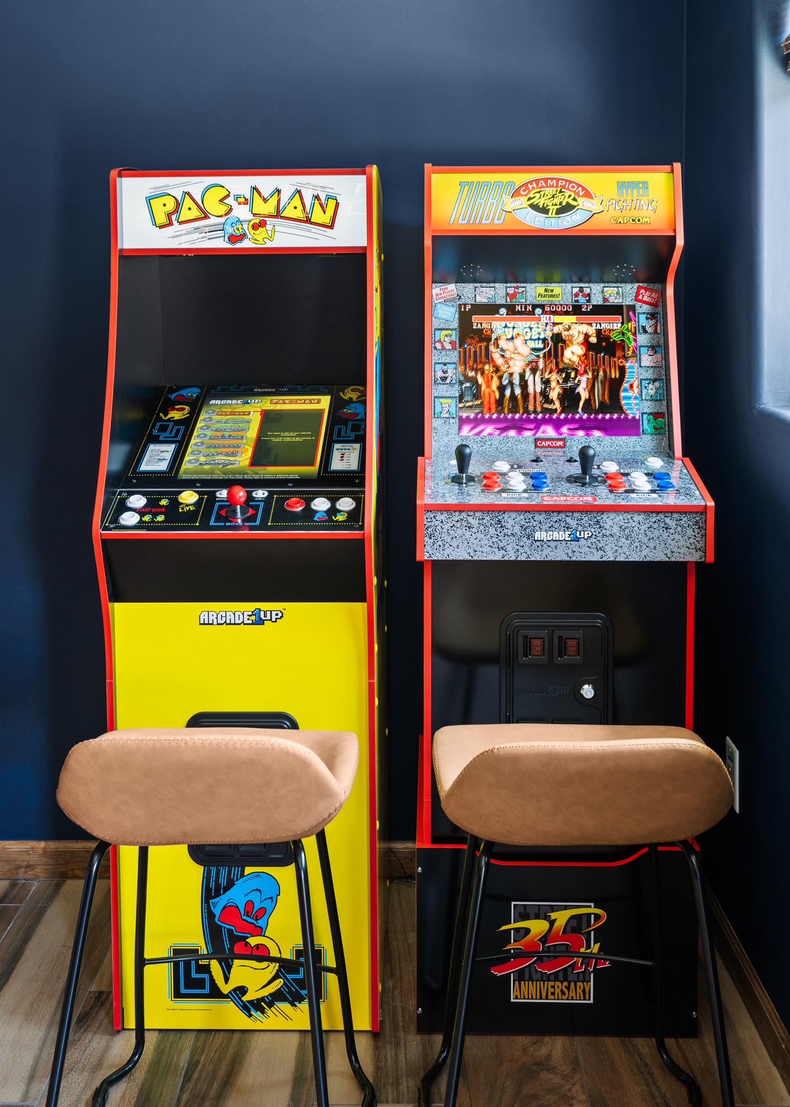Retro gaming corner with classic arcade machines: Pac-Man and Street Fighter II Turbo.