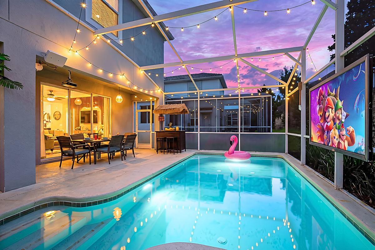 Sunset swims and movie nights! Enjoy the sparkling private pool, outdoor dining, tiki bar, and a big-screen movie—all from your screened-in tropical retreat.