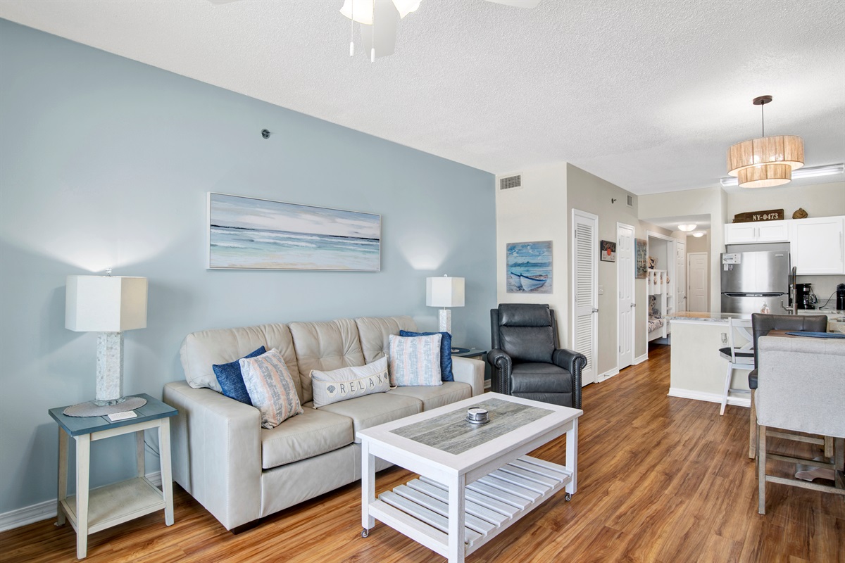 Living room with sleeper sofa, recliner, arm chair, ceiling fan, wall mounted Smart TV and a great Gulf and beach view 