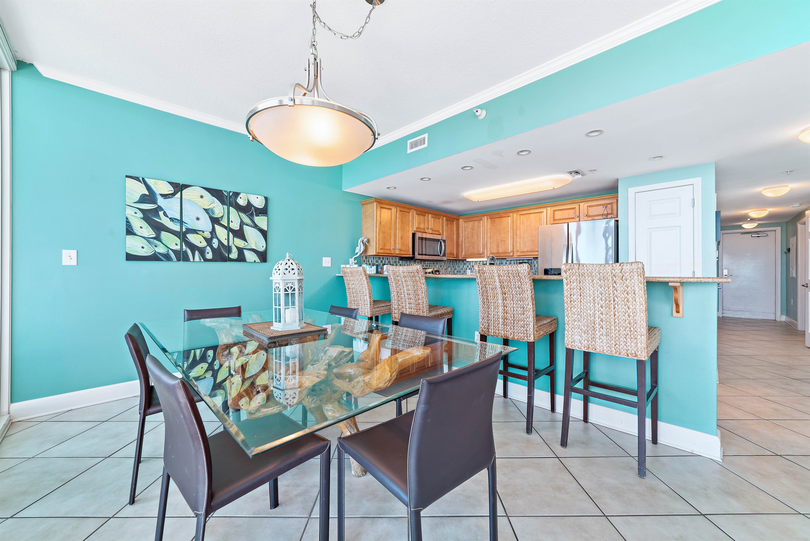 Dine in style with ample space for everyone. This inviting dining area features a charming table for family meals, complemented by additional seating at the convenient breakfast bar.