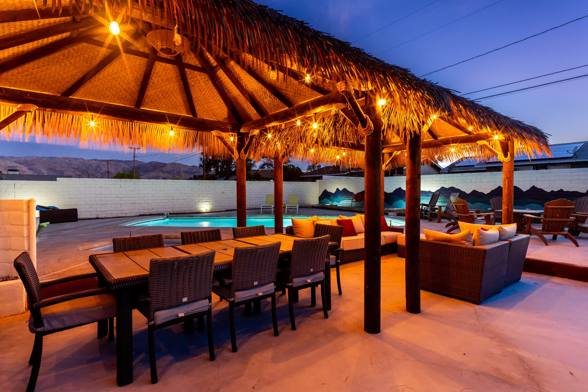 Palapa dining at dusk under string lights, dinner outside in the Joshua Tree desert